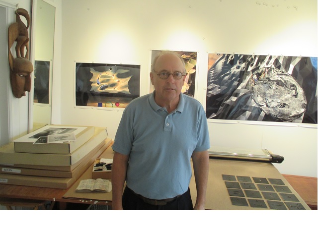 David Brenkus stands in front of some of his work