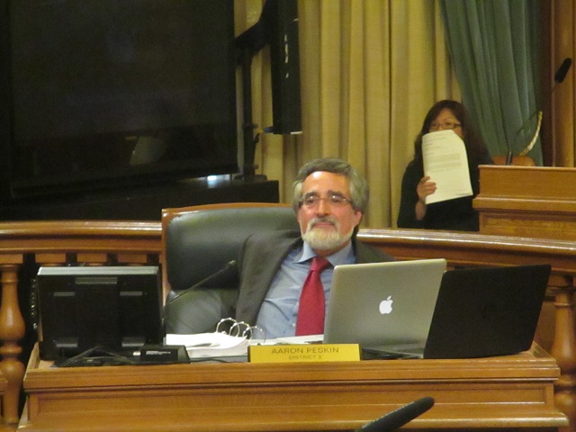 Sup. Aaron Peskin happily settles into a chair at this week's board meeting
