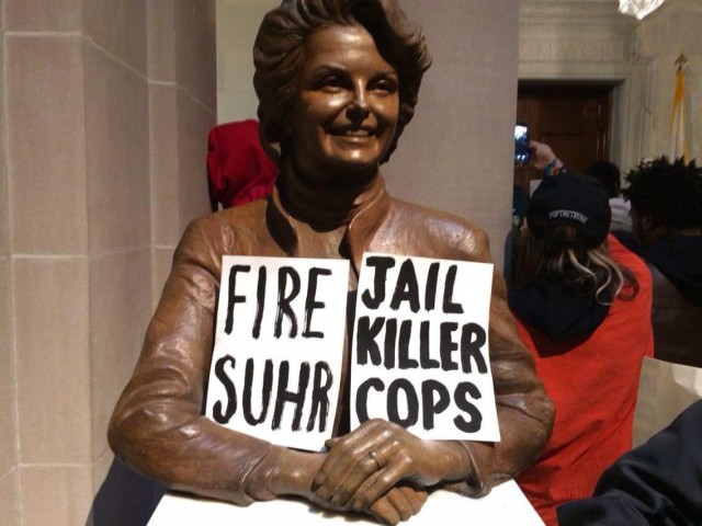 A bust of former Mayor Dianne Feinstein carries the message of the protest