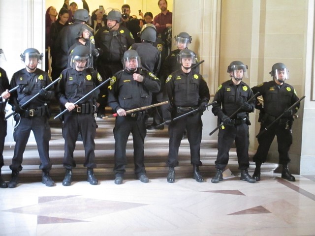 The Tac Squad lines up to roust protesters -- which would have been a very bad idea