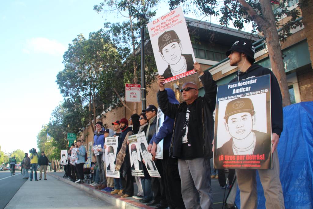 Supporters stand in an hour long silent vigil outside Mission Police Station. Photo By Sana Saleem