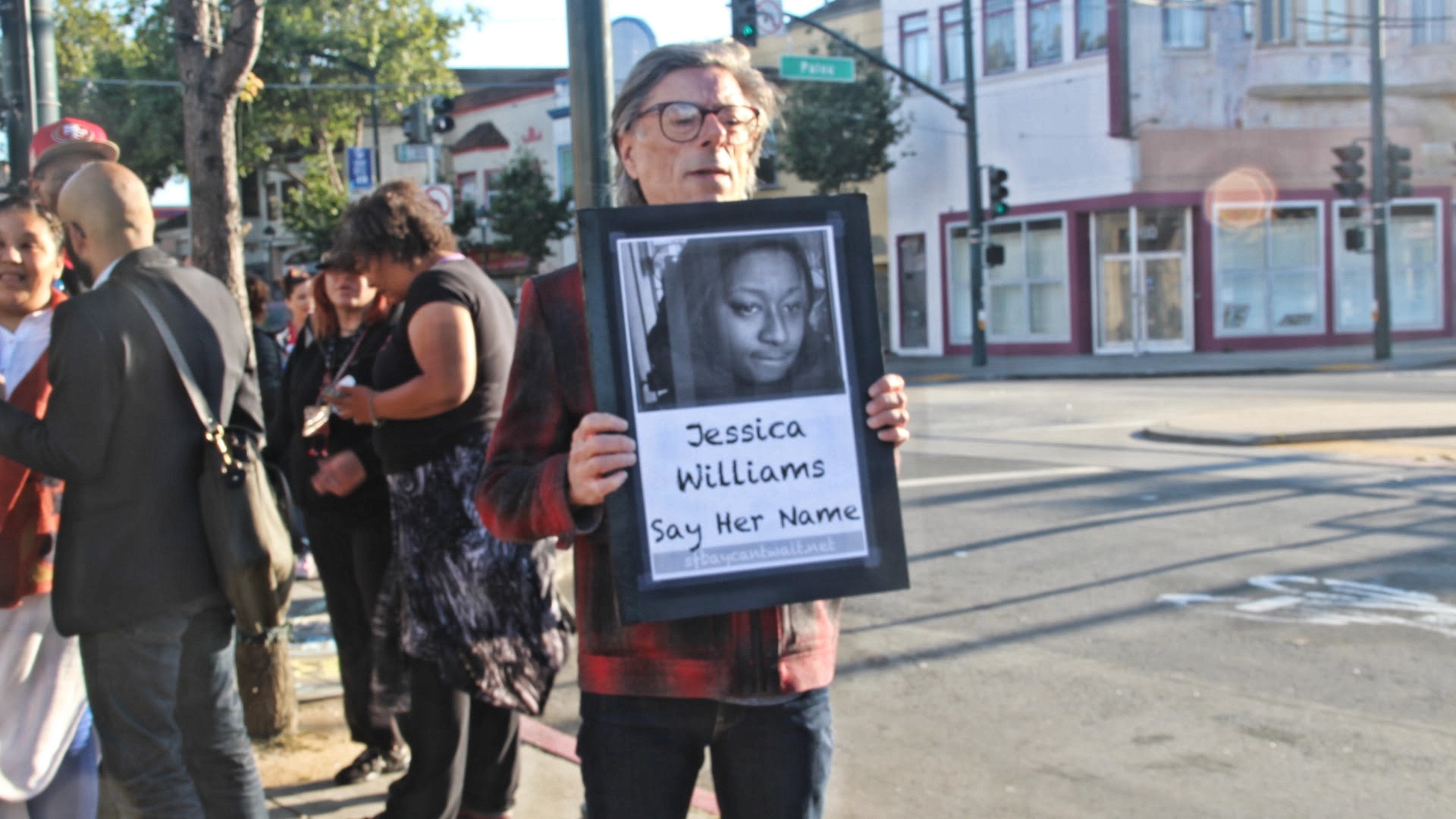 A protestor holds a photo of Jessica William, provided by her family. Photo by Sana Saleem