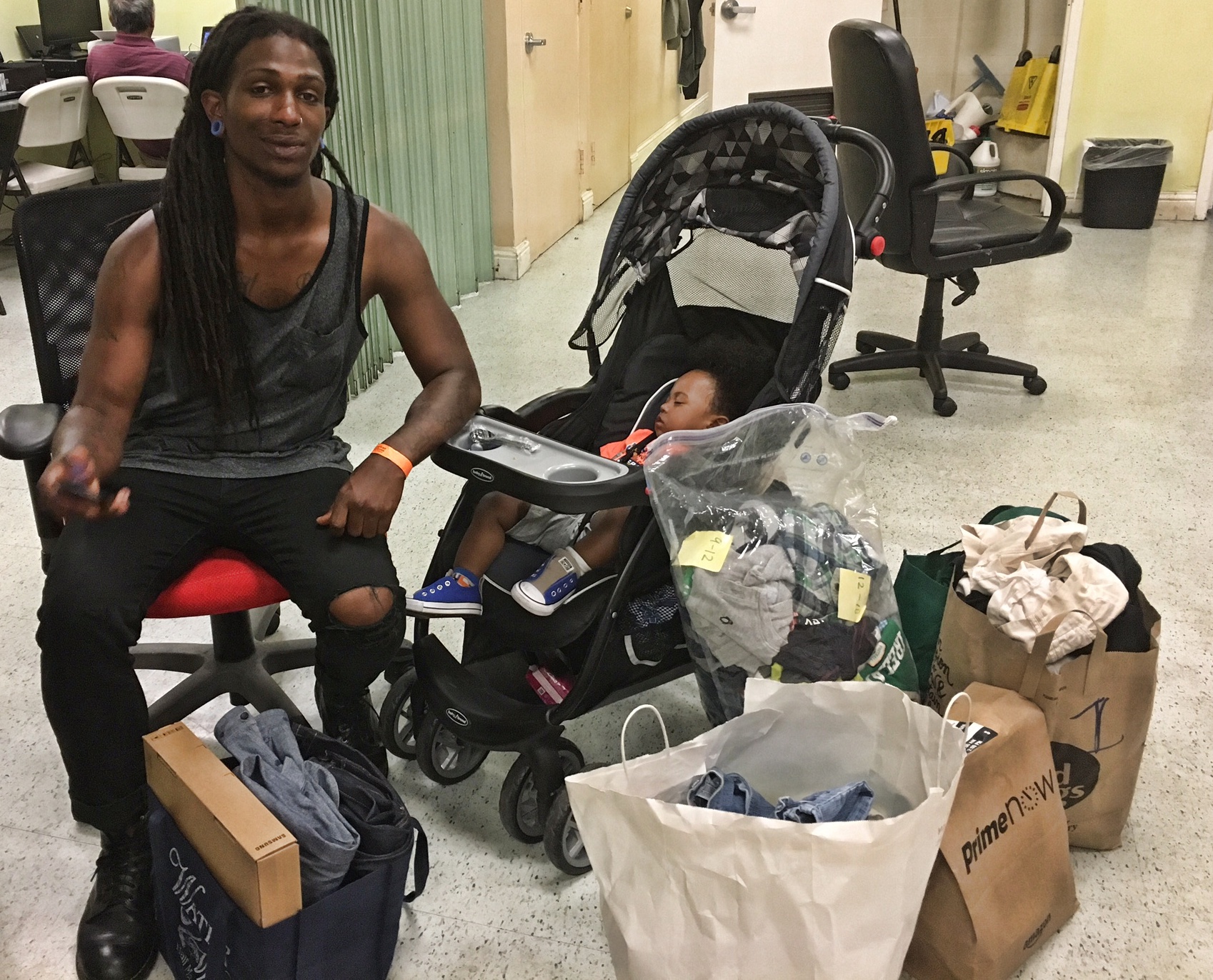 "I am so happy, people are way too kind" Williams said as he sat with his one year old son and donations they received from the community. Photo by Sana Saleem