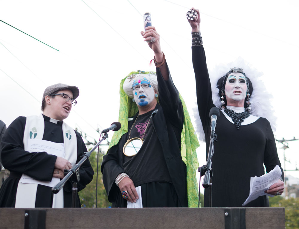 The Sisters of Perpetual Indulgence lead the crowd in chants of "Raise your light high!"