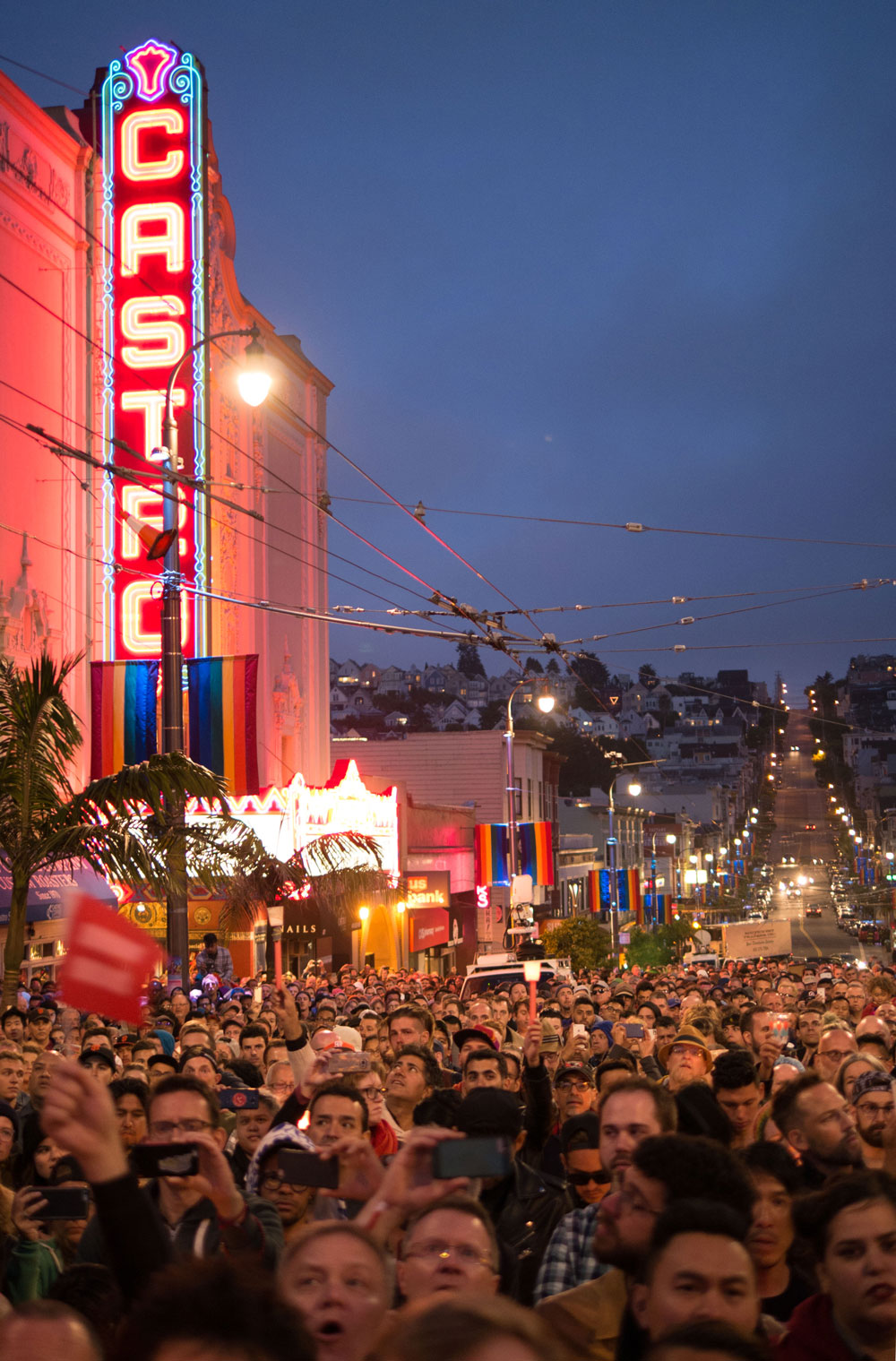 As the speakers went on and the crowd grew, darkness began to fall and the Castro filled with candlelight. Photo by David Schnur. 