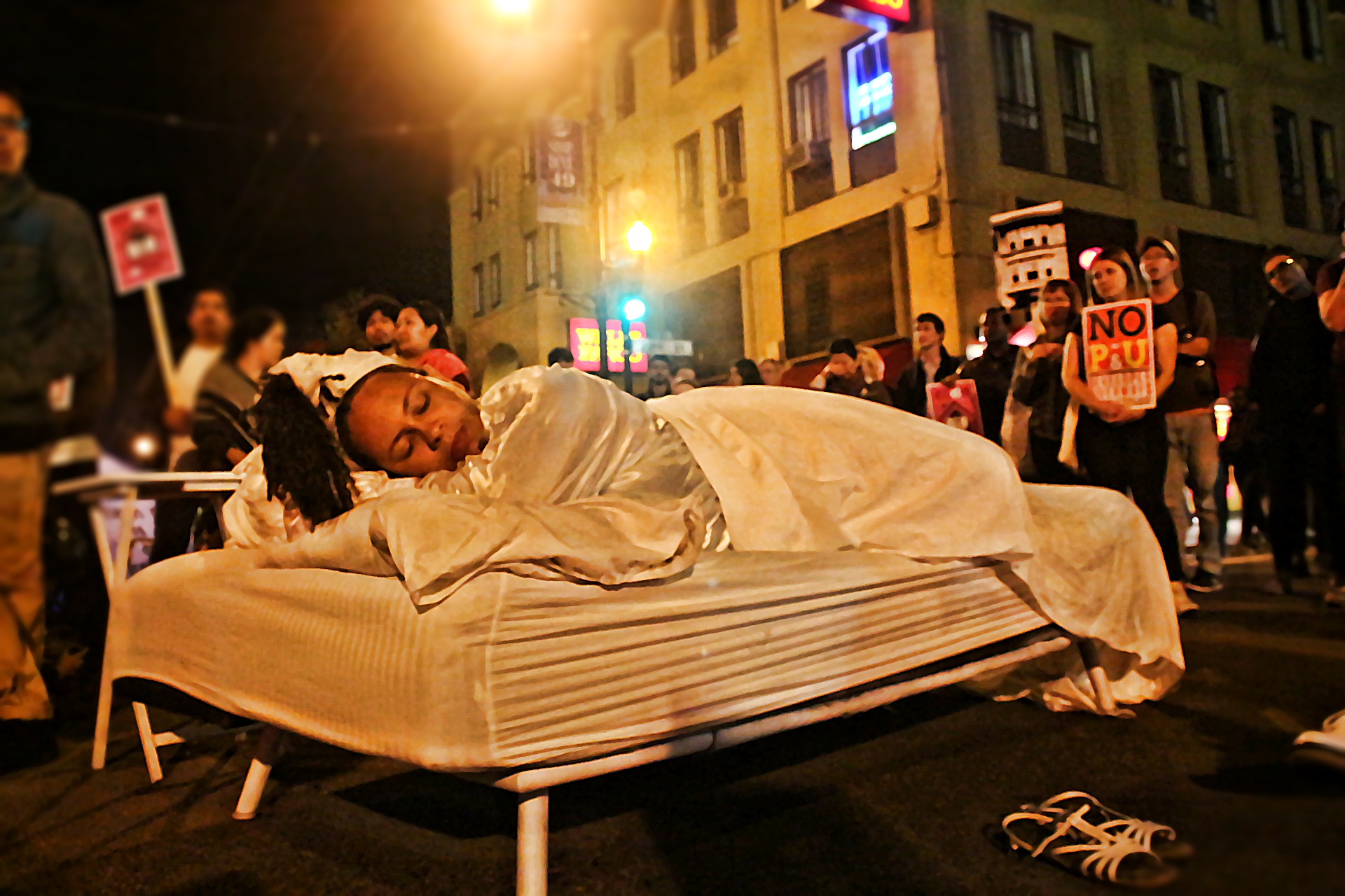 Alicia Bell, from the San Francisco Anti-displacement coalition, engages in performance art at the Mission and 22nd intersection. Photo by Sana Saleem