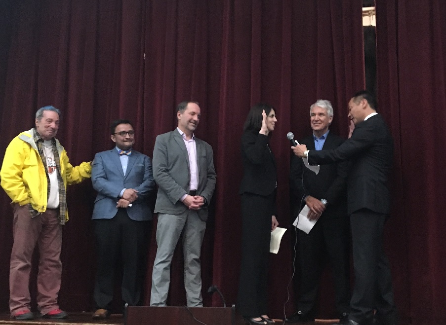 Hillary Ronen is sworn in by DA George Gascon and Public Defender Jeff Adachi, with her husband, Francisco Ugarte, and David Campos and Tom Ammiano on the stage