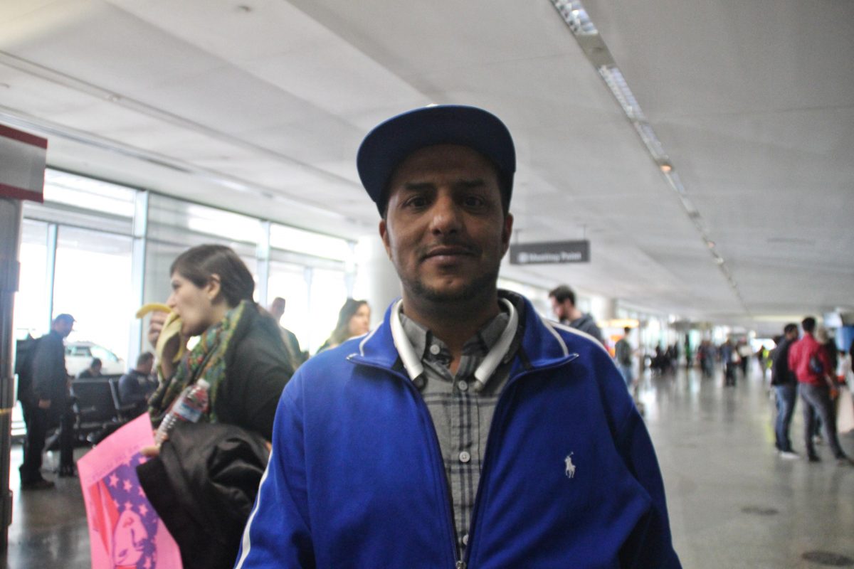 Abrahim Abuzeid says he was anxious for his brother's arrival but comforted when he saw the crowds of supporters against the #muslimban. Photo by Sana Saleem. 