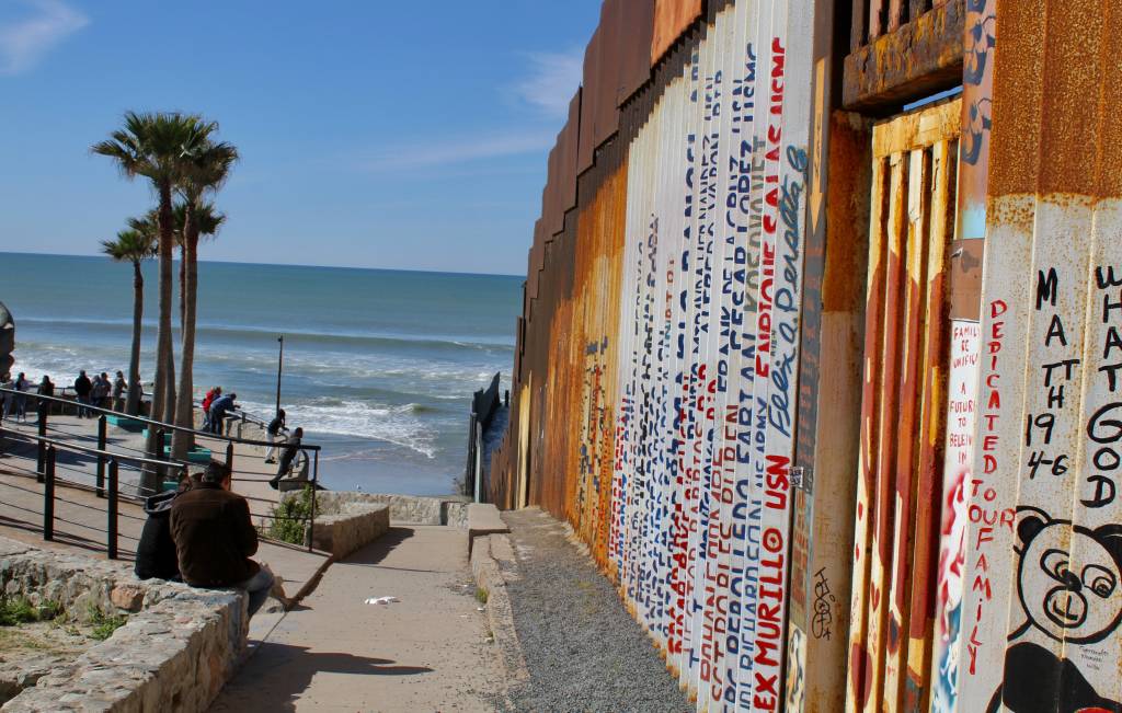 Names of veterans who fought in the United States army and who were later deported from the country are written along the border wall at the shuttered Friendship Park. Photo by Matthew Suárez