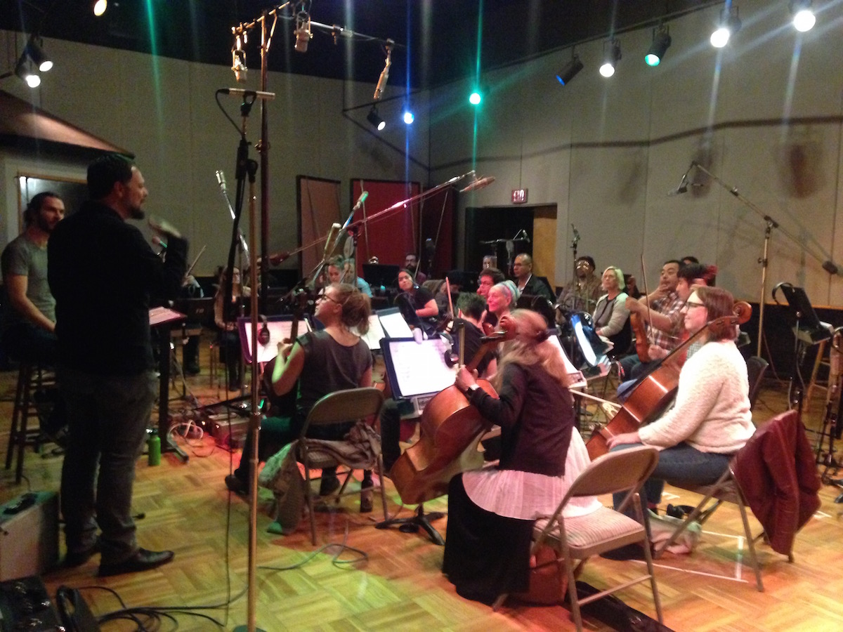 Joe Bagale discussing his arrangement of "A Day in the Life" with members of Awesome Orchestra. Photo by Joanna Ladd.